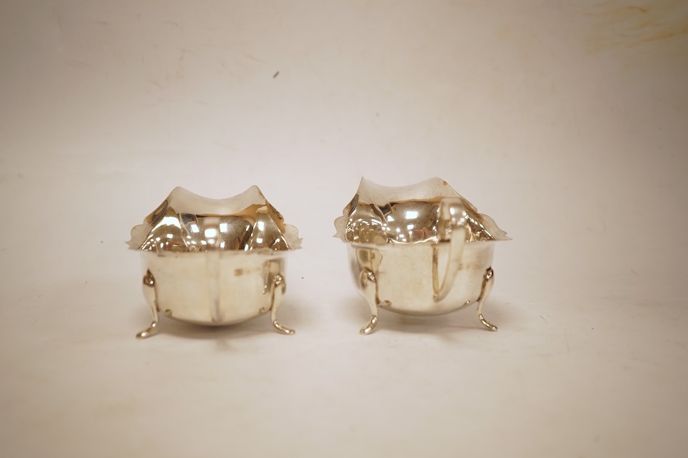 A pair of 1930's silver sauceboats, with cut borders, Barker Brothers Silver Ltd, Birmingham, 1935 and 1938, length 14.6cm, 5.8oz.